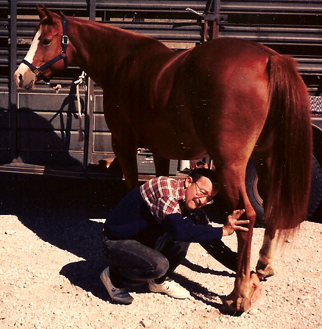 Erick in October, 1994, grooming Lady prior to riding at Guadalupe Peak