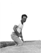 Frank William Abner Conard on a pile of wheat he harvested in 1947