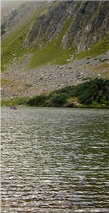 Goose Lake with boat and cliffs in distance