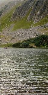 Goose Lake with boat and cliffs in distance