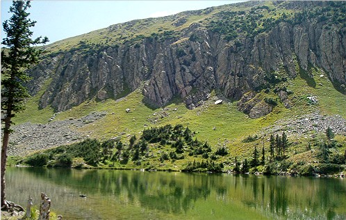 Goose Lake with boat and cliffs in distance